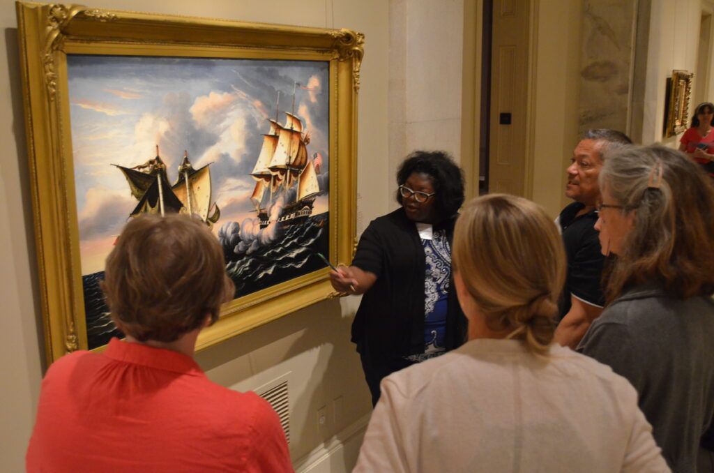photo of patrons looking at a work of art