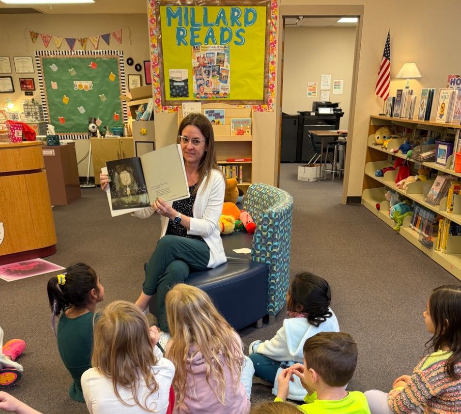 Teacher Apprentice Jackie Bergmann reading a book to her students