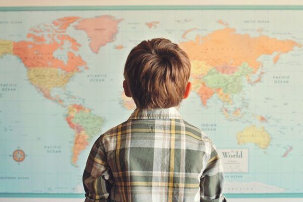 Back of young child looking at world map